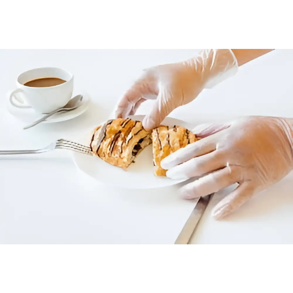 Individual demonstrating the use of Diamond Clear 4 mil Vinyl Powder Free Gloves while handling food